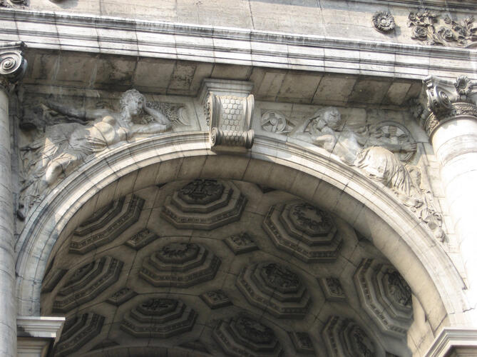 Arcade du Cinquantenaire, <a href='/fr/glossary/274' class='info'>écoinçons<span>Espace de mur ménagé de part et d’autre d’un arc.</span></a> ornés de bas-reliefs allégoriques (photo 2007).